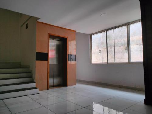 an empty room with a door and a window at Kings Fort Rooms Thrippunithura in Ernakulam