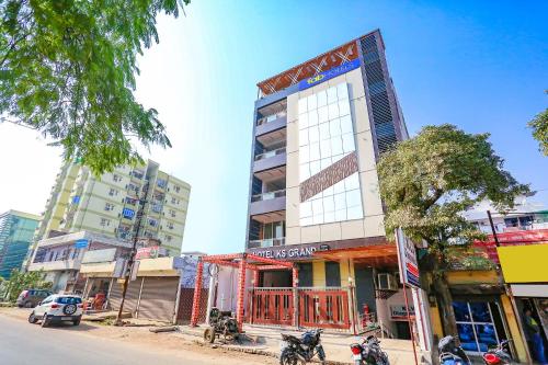 a tall building with motorcycles parked in front of it at FabHotel KS Grand in Kānpur