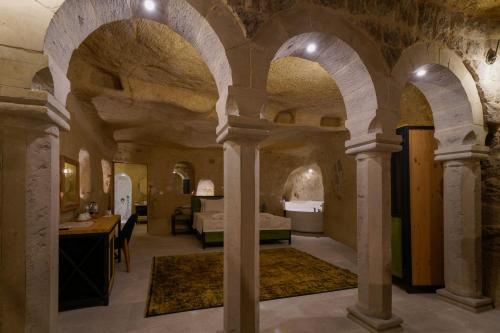 a room with arches and a bedroom in a house at The Niche Cave Hotel in Goreme