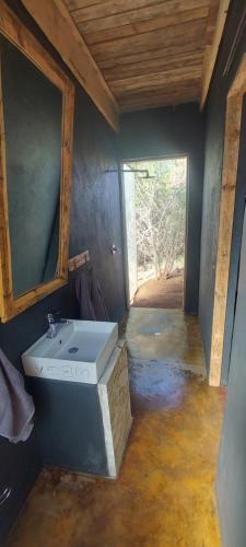a bathroom with a sink and a window at Hartbees Eco Bush Lodge 1 in Hartbeespoort