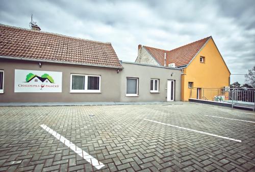 a parking lot in front of a building at Chaloupka víno sklep U Palečků in Zaječí