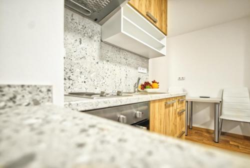 a kitchen with a counter top and a table at Chaloupka víno sklep U Palečků in Zaječí