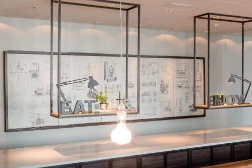 a room with drawings on the wall at Motel One München - Deutsches Museum in Munich