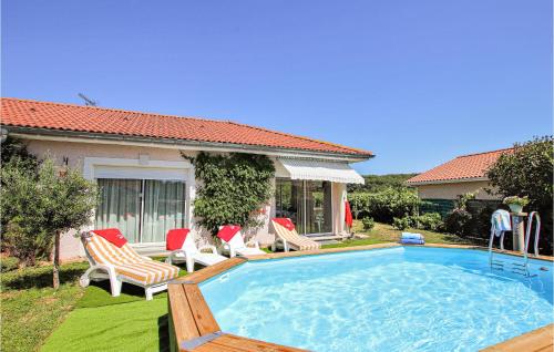 a swimming pool in a yard with chairs and a house at 2 Bedroom Stunning Home In Flachères in Flachères