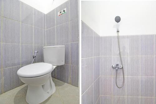 a bathroom with a toilet and a shower at Super OYO Collection O 92363 Kp Inn in Yogyakarta