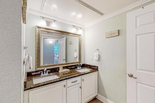 Baño con 2 lavabos y espejo en Whitecap Retreat en Padre Island