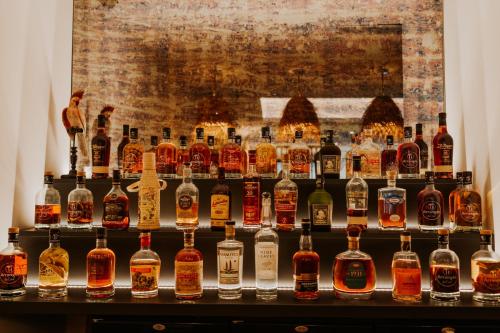 a display of bottles of whiskey on a shelf at Palm Boutique Hôtel Nice in Nice