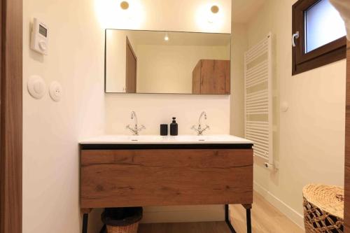 a bathroom with a sink and a mirror at Chalet Ameo in Valdeblore