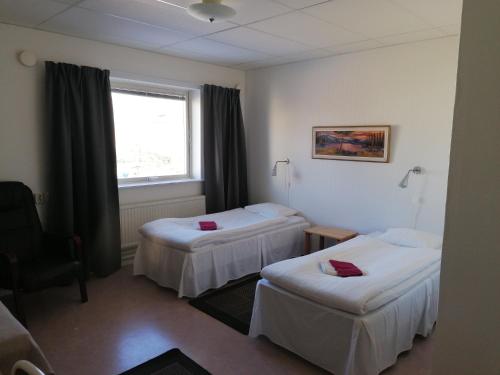 Säng eller sängar i ett rum på Hotell Hemgården