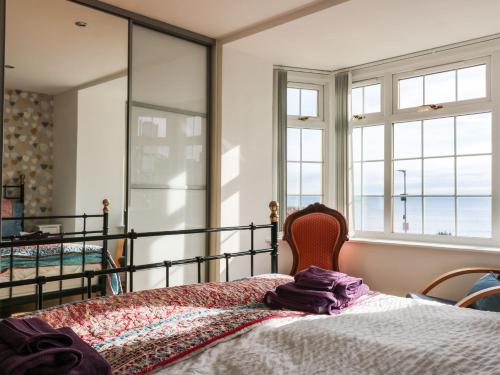 a bedroom with a bed and a large mirror at Beach Cottage in Kinghorn