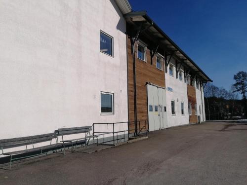 a building with benches on the side of it at Hotell Hemgården in Bengtsfors