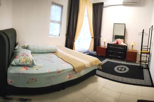 a bedroom with a bed and a mirror at Casa Klebang Homestay in Ipoh