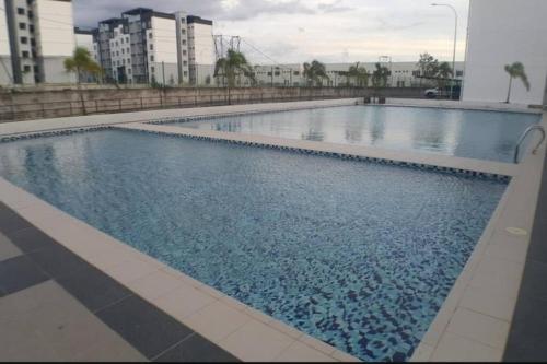 a large swimming pool with blue water in a building at Casa Klebang Homestay in Ipoh