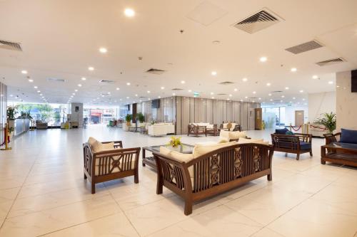 a large lobby with tables and chairs in a building at Virgo Hotel Nha Trang in Nha Trang