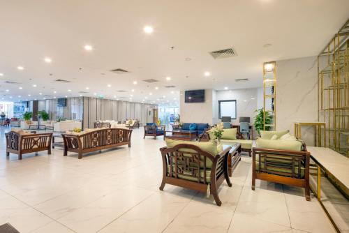 a lobby with chairs and tables in a building at Virgo Hotel Nha Trang in Nha Trang