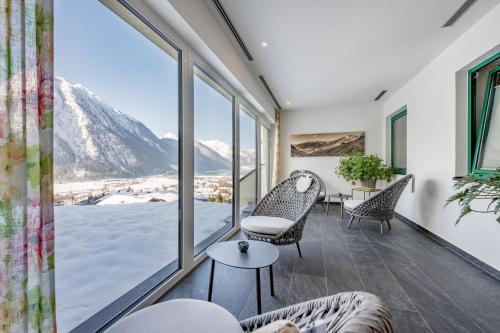 a living room with a view of a mountain at Naturhotel Alpenblick in Maurach