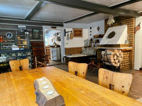 a dining room with a wooden table and chairs at Roubenka u potoka Jizerské hory in Desná