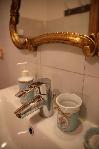 a bathroom sink with a coffee cup and a faucet at Agriturismo alle Torricelle in Verona
