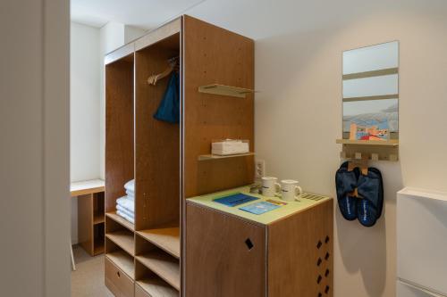 a room with a closet with a desk and shelves at Mangrove Dongdaemun in Seoul