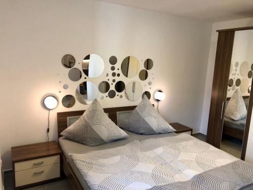 a bedroom with a bed with mirrors on the wall at Erdgeschoss-Appartement mit Seeterasse in Ahrensbök