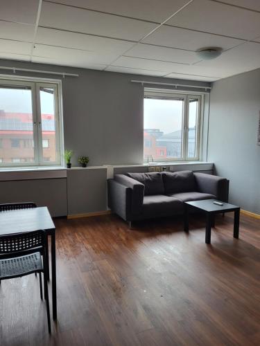 a living room with a couch and a table at Apartments Centralstation in Uppsala