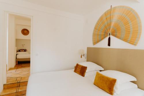 a bedroom with a bed with an umbrella on the wall at Palm Boutique Hôtel Nice in Nice
