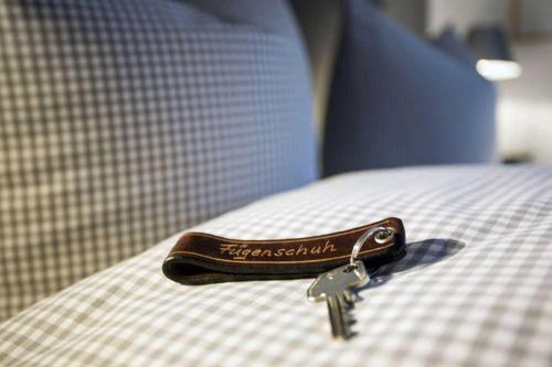 a pair of keys sitting on top of a bed at Fügenschuh's Ferienwohnungen in Bad Hindelang