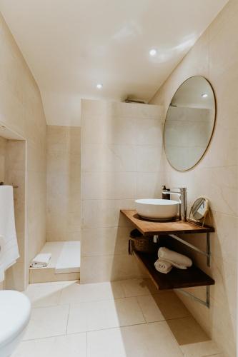 a bathroom with a sink and a mirror at Palm Boutique Hôtel Nice in Nice