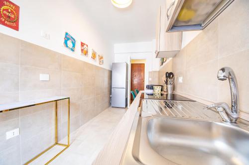 a kitchen with a large sink in a room at My Vatican Place in Rome