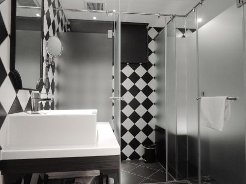 a bathroom with a sink and a shower at CHECK inn Taipei Main Station in Taipei