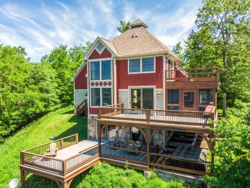 a home with a large deck and a house at Hawk Mountain in McHenry