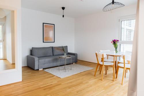 a living room with a couch and a table at Modern Apartment with free garage in Vienna