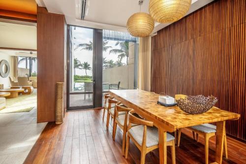 a dining room with a wooden table and chairs at Villa seaview and apartment -Spa Da Nang Resort by JT group "Free pick up" in Da Nang