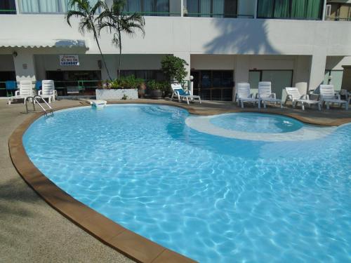 a large swimming pool in the middle of a hotel at Condopatong in Patong Beach