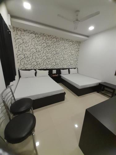 Postel nebo postele na pokoji v ubytování Hotel Shree