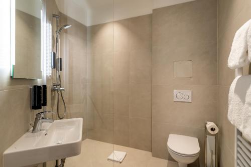 een badkamer met een wastafel, een toilet en een douche bij DaunTown Rooms - Self Check-In in Wenen