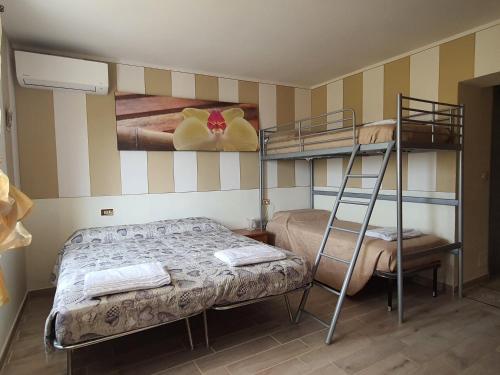 a bedroom with two bunk beds and a ladder at La corte delle fate in Lonato