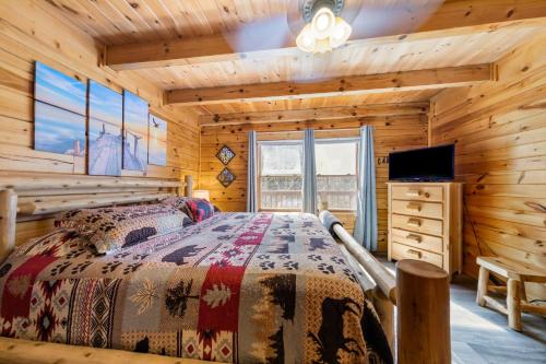 a bedroom with a bed in a log cabin at Serenity, A Rustic Log Cabin Retreat in Sevierville