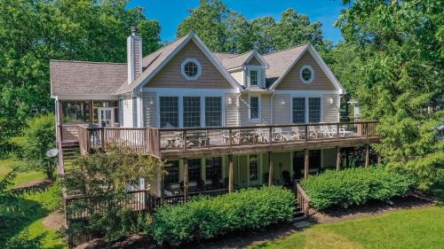 a large house with a wrap around deck at Stilwater Serenity in Swanton