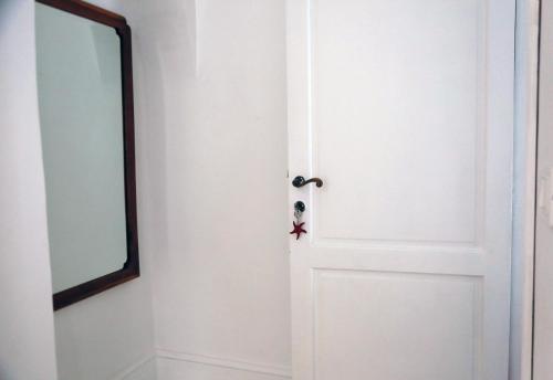 a white door with a mirror and a star on it at dimore di portadibasso in Peschici