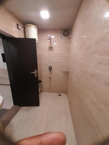 a room with a bathroom with a black door at Hotel Shree in Hisār