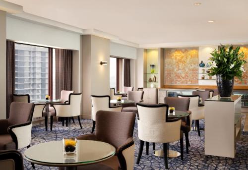 a restaurant with tables and chairs and a lobby at Sheraton Imperial Kuala Lumpur Hotel in Kuala Lumpur