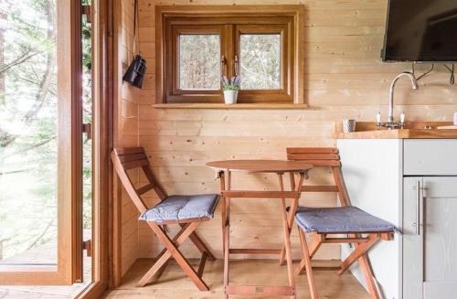 a small kitchen with a table and two chairs at The hideaway in Bristol