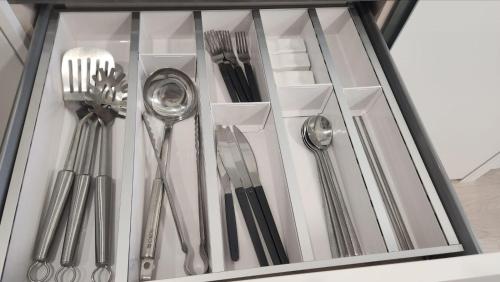 a group of silver utensils in a drawer at UH FLAT The SONGDO in Incheon