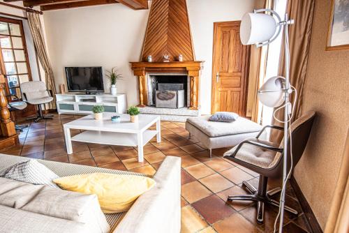 a living room with a couch and a fireplace at Maison familiale in Moncoutant