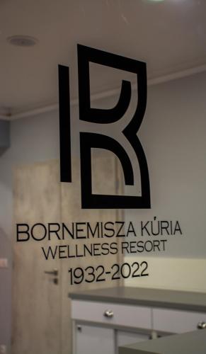 a sign for a wellness resort on a wall at Bornemisza Kúria Wellness Resort in Tiszabecs