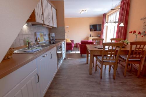 a kitchen with a table and a dining room at Villa-Senta-Apartment-9 in Kühlungsborn