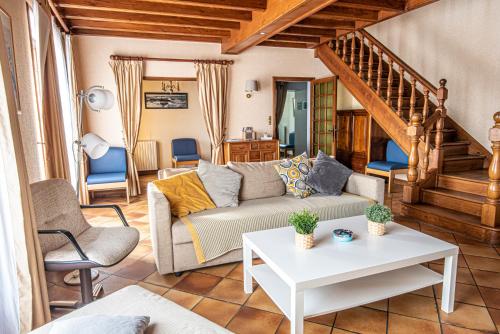 a living room with a couch and a table at Maison familiale in Moncoutant