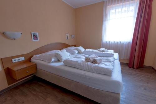 a bedroom with a bed with towels on it at Villa-Senta-Apartment-11 in Kühlungsborn