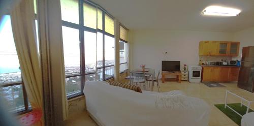 a living room with a white couch and large windows at Amazing Panorama Bay view 3 room flat in Haifa